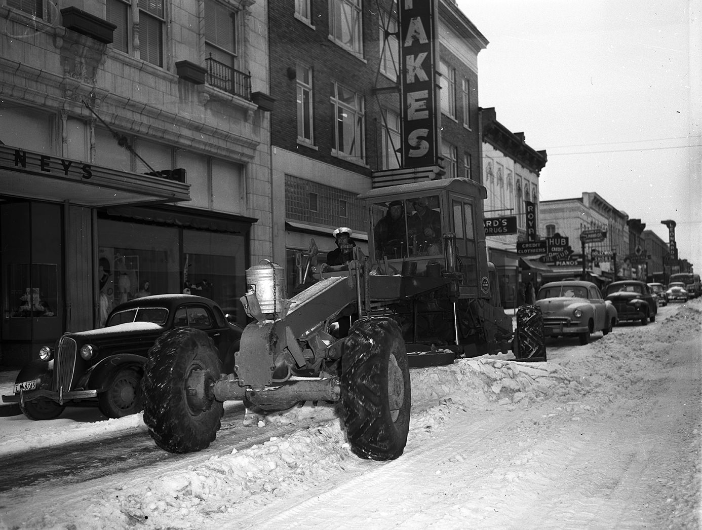 #102 City snow plow on Houston Street, clearing sleet and snow, 1951.
