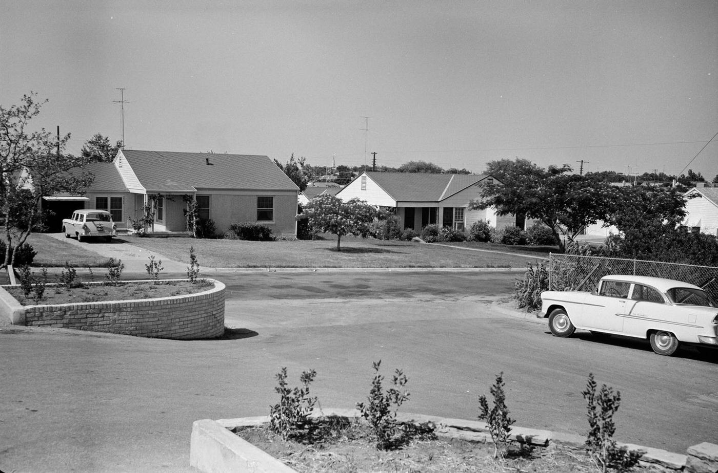 #15 A Fort Worth neighborhood street scene with parked cars, 1950s.