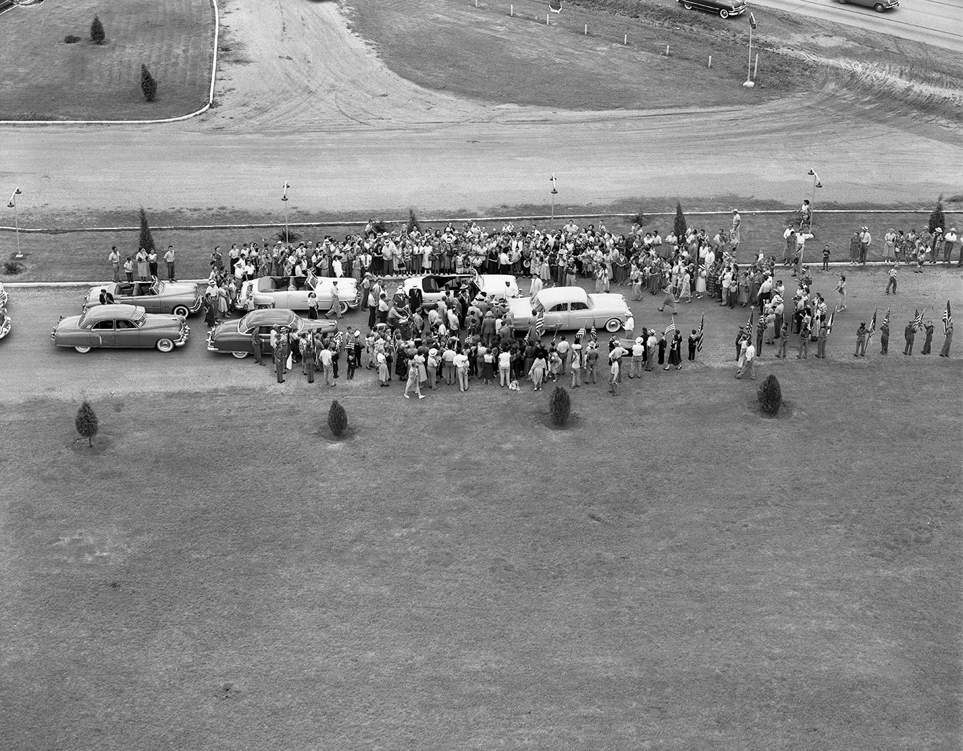#73 Crowd gathered at the Pike Drive-in Theater cheered as General Douglas MacArthur got into a waiting convertible for the parade, 1951.