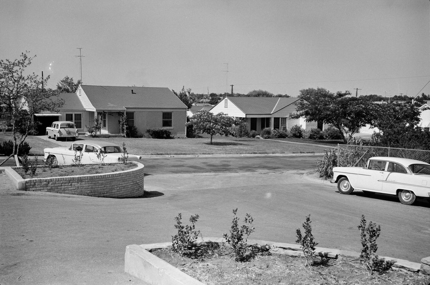 #42 A Fort Worth neighborhood street scene with parked cars, 1950s.