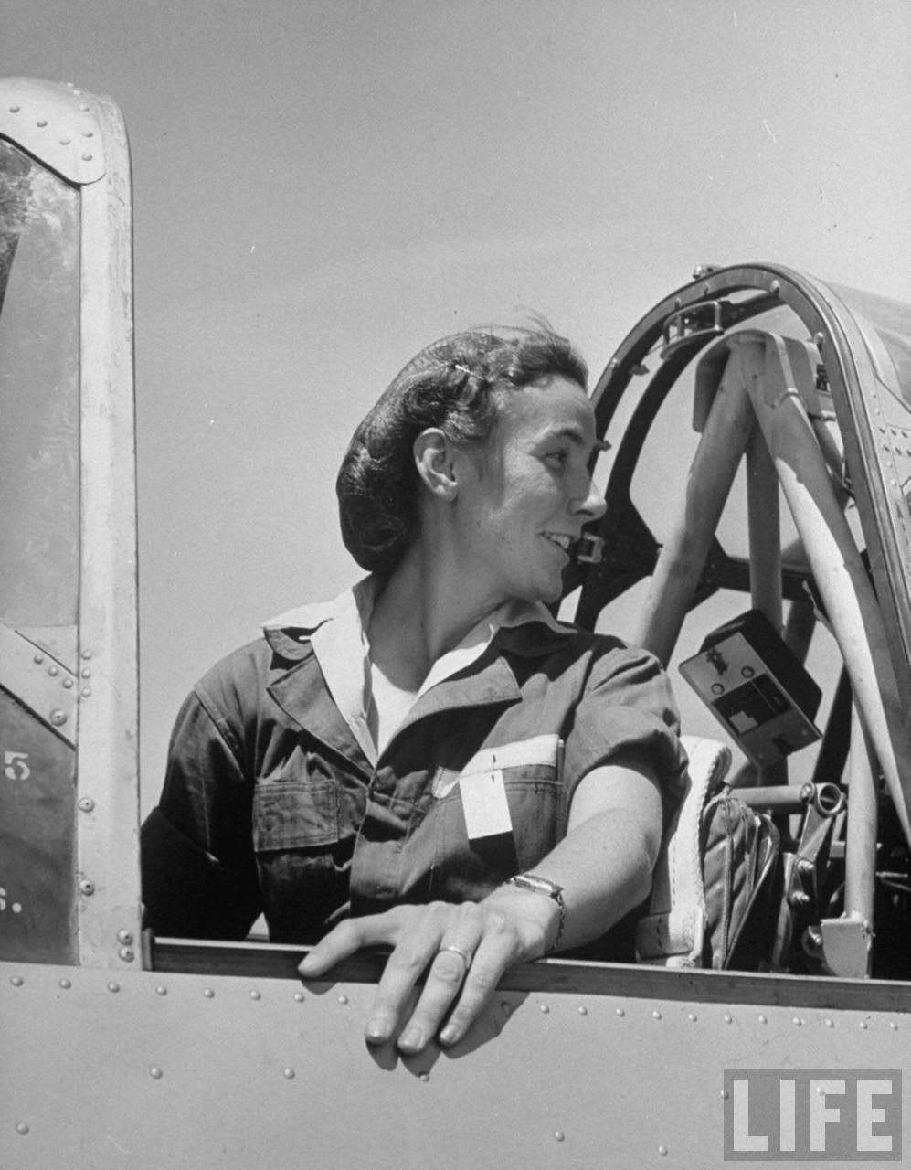 #13 Forence Knight, pilot trainee in Women’s Flying Training Detachment, to qualify for joining the all-civilian Women’s Auxiliary Ferrying Squadron, using a hairnet to keep hair fr. flying, in cockpit of trainer before takeoff at Avenger Field.