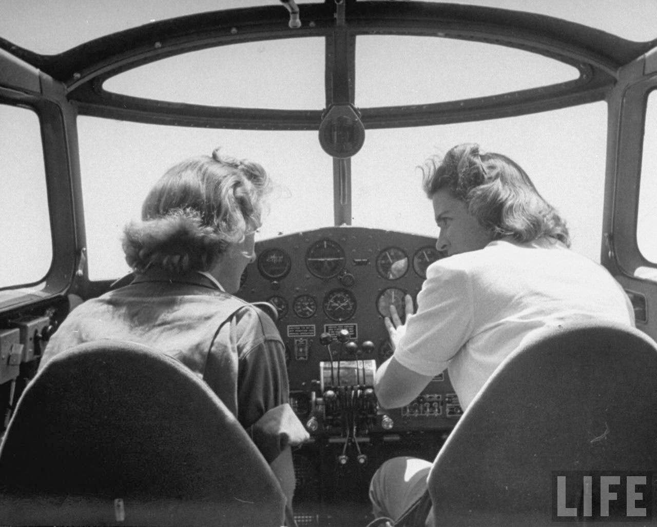 #3 Flying instructor Helen Duffy (R) going over cockpit procedure w. one of her advance pilot trainees in the Women’s Flying Training Detachment, as she trains them to qualify for the all-civilian Women’s Auxilary Ferrying Squadron, at Avenger Field.
