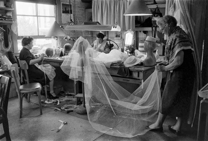 Seamstresses work on Grace Kelly’s wedding dress and veil, conceived by MGM’s wardrobe designer, Helen Rose, Hollywood, Calif., 1956