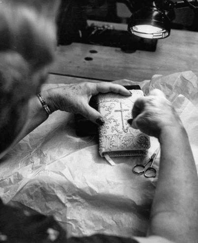 A woman puts the finishing touches on the pearl-studded prayer book for Grace Kelly’s wedding, Hollywood, Calif., 1956