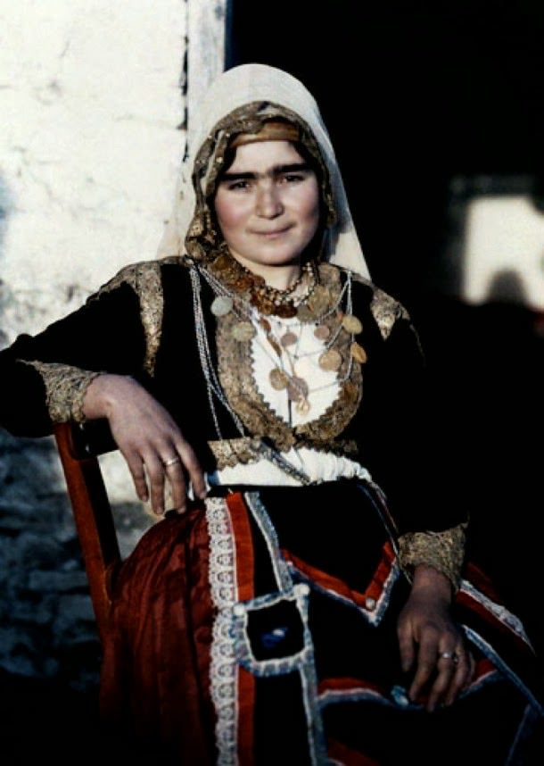 A woman poses in the national costume of Crete.