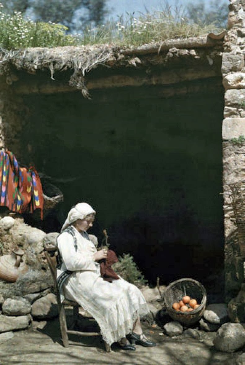 A woman works outside her home in Crete.