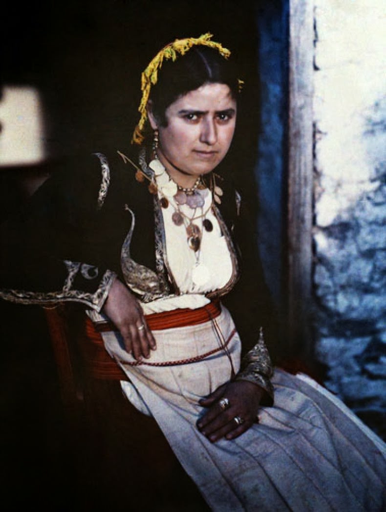 A woman poses in the national costume of Crete.