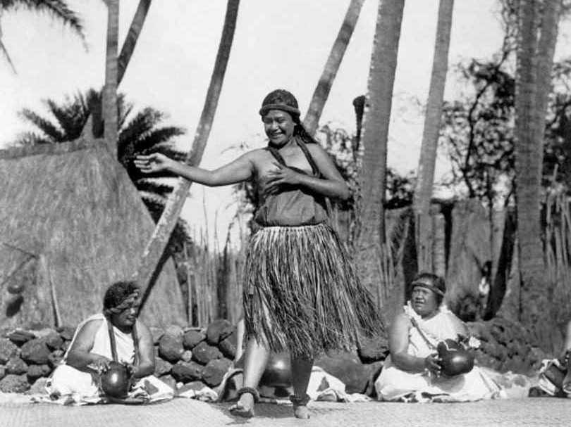 #83 A native Hawaiian dancer performs while other women keep rhythm with gourds, 1924.