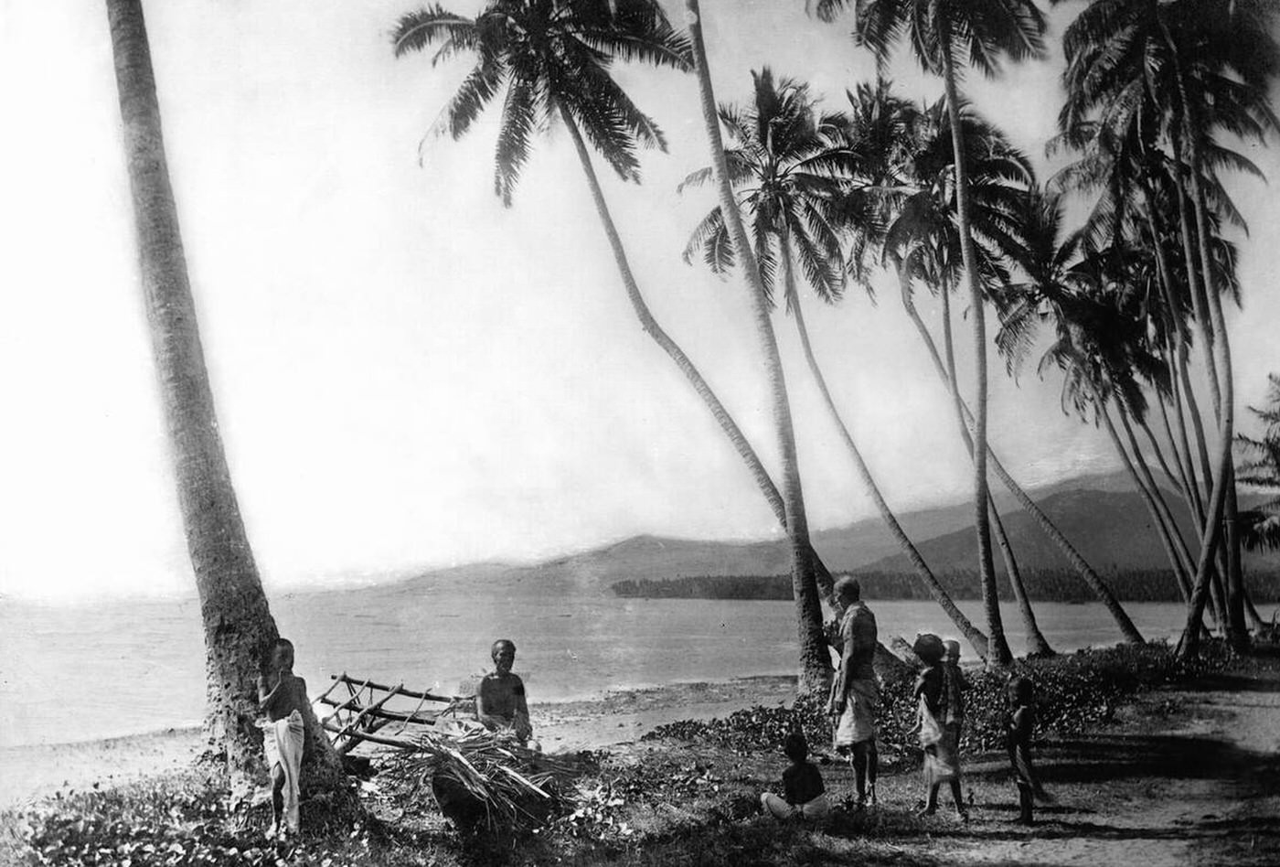 #6 A Native Hawaiian family on a beach near coconut palm trees, 1907.