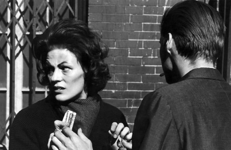 #10 Karen keeping a furtive eye out for detectives, hands a pusher $5 for a bag of heroin.