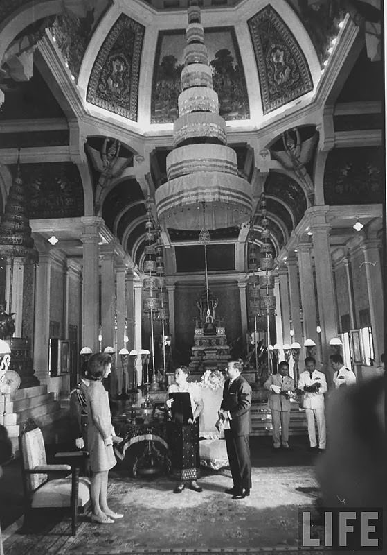 #7 Jackie Kennedy exchanging gifts with Prince Norodom Sihanouk and the Queen Mother in the throne roo of the royal palace 1967