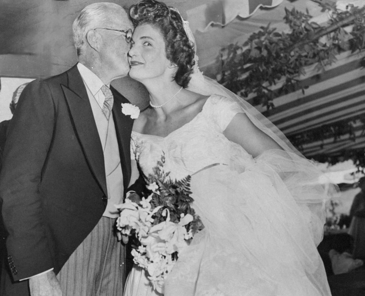 #20 Jacqueline Bouvier Kennedy receives a kiss from her father-in-law, Joseph Kennedy, after her wedding, 1953.