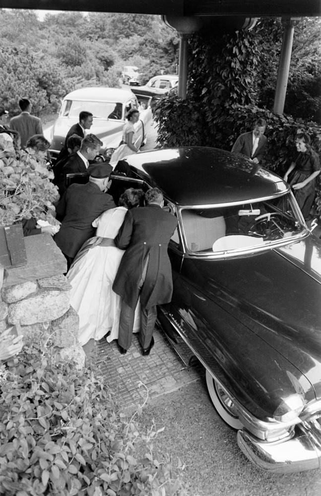 #12 Well-wishers gather around the car carrying the newlyweds to their reception, Newport, Rhode Island, 1953.