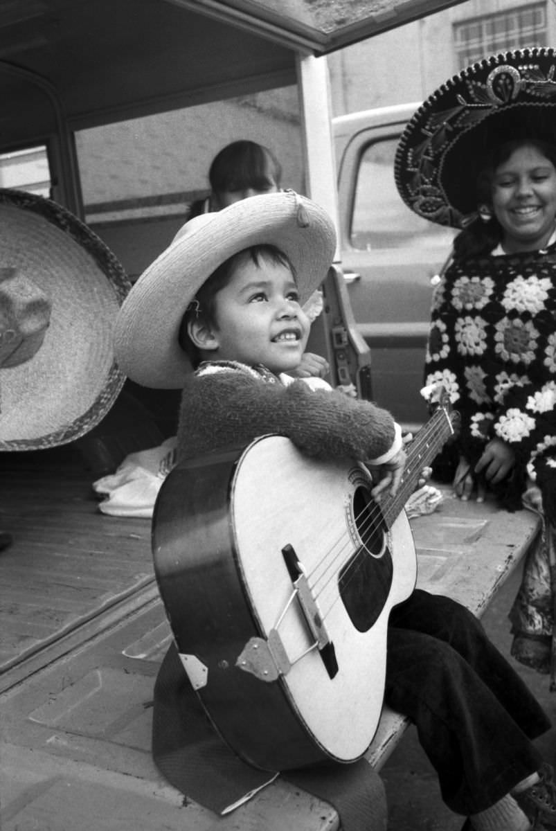 #1 Michael Cerda holds a guitar during the Mexican Independence Day parade in Fort Worth, Texas, 1974.