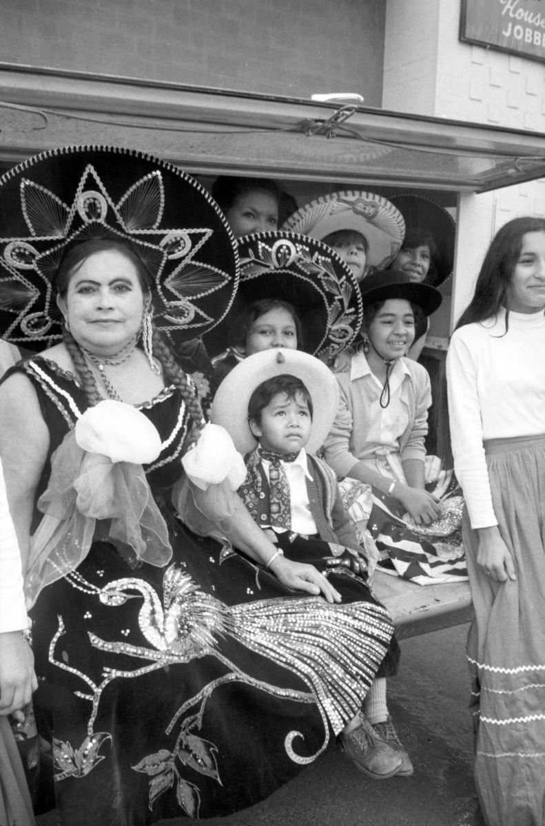 #9 The Cerda family, in traditional Mexican attire, watches the Mexican Independence Day parade in Fort Worth, Texas, 1974.