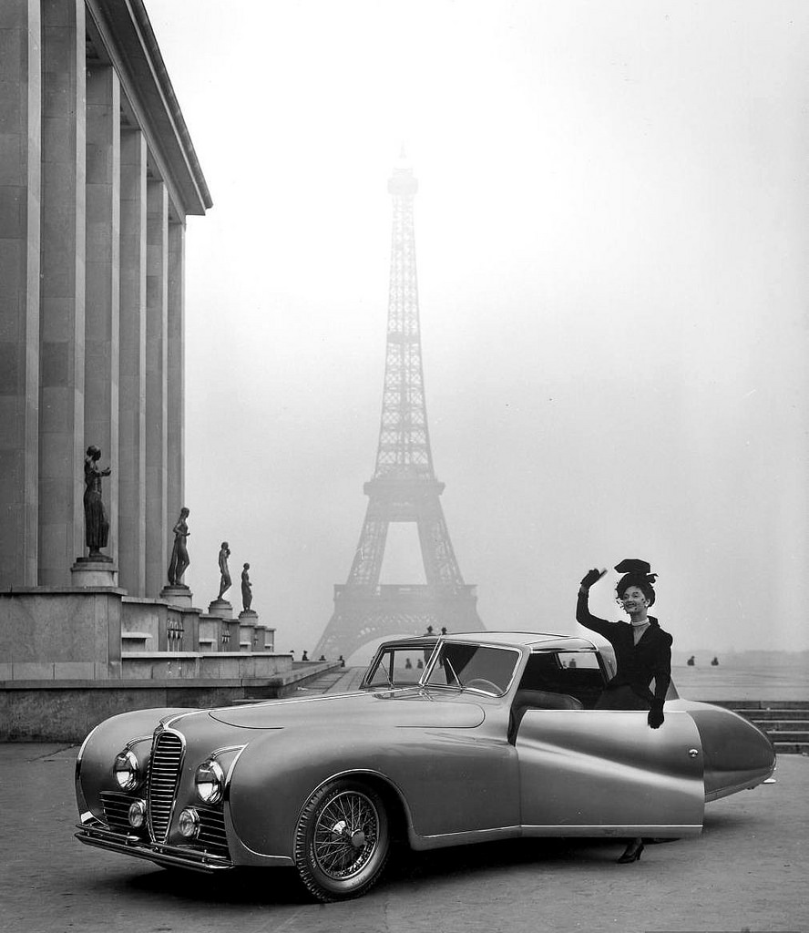 #12 Model and 1947 Delahaye automobile against background of the Eiffel Tower, photo by Tony Linck, 1947