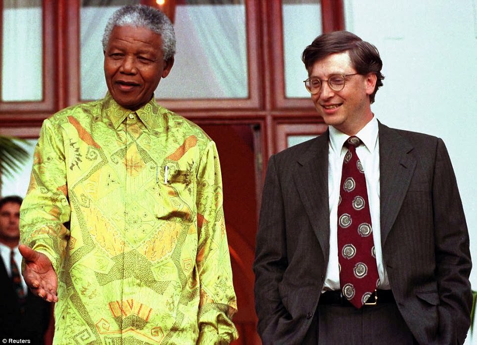 #20 South African President Nelson Mandela (L) shares a joke with Microsoft Chairman Bill Gates after their meeting at Mandela’s residence in Cape Town, in this file picture taken March 11, 1997.