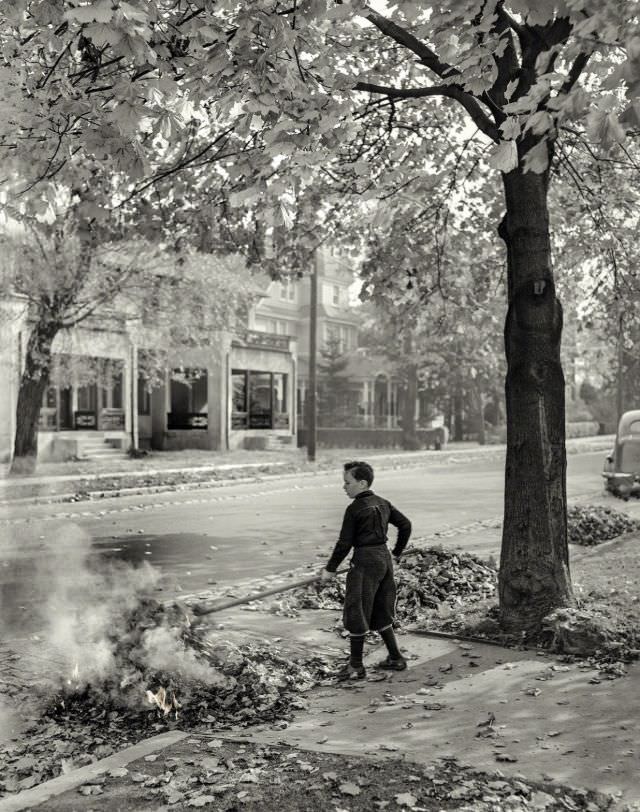 #28 Burning fallen leaves, New York City suburbs, 1941.