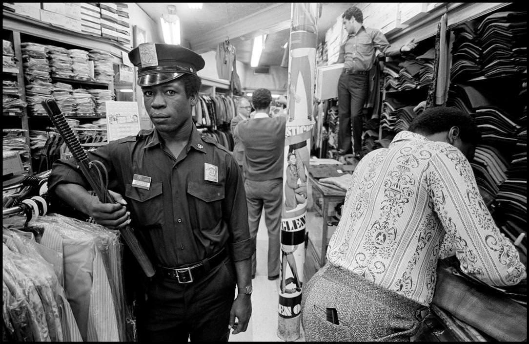#38 A security guard at a clothing store, 1972.