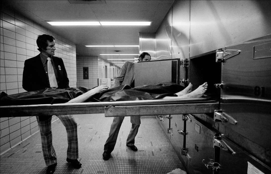 #42 Detectives remove fingerprints from the body in the morgue, 1972.