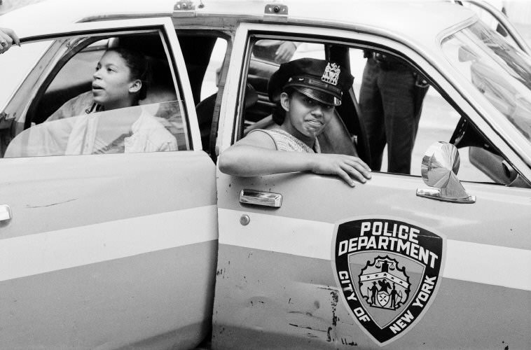 #71 Children play in a police car on one of the hottest days of July, 1979.
