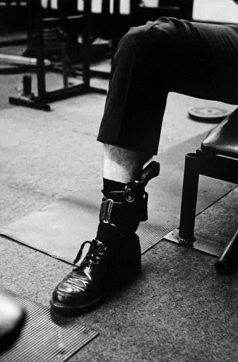 #75 The officer shoots a gun with an ankle before school in the gym, 1979.