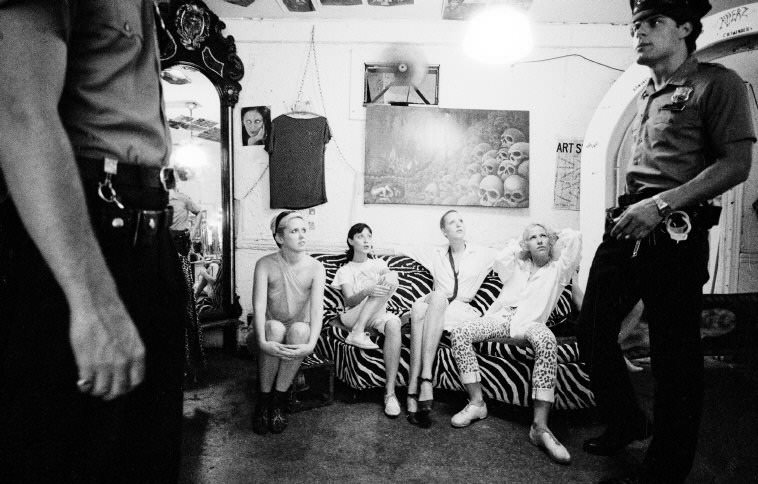 #83 Police officers during a visit to a countercultural clothing boutique, 1979.