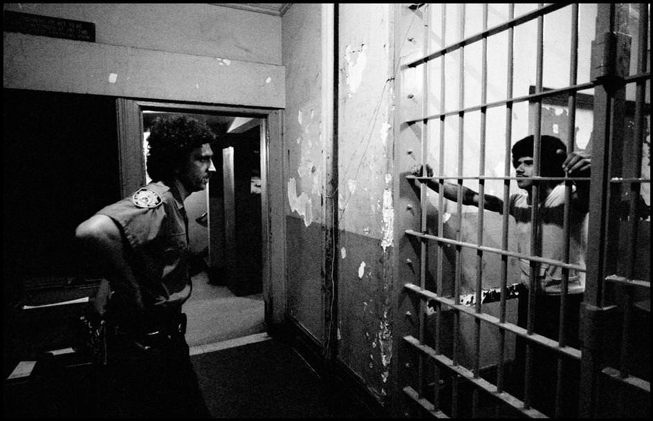 #89 The detainee and the officer looked at each other in a police station, 1978.
