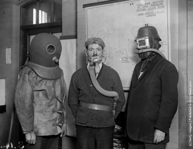 #26 Workers demonstrating different types of mine rescue gas masks, 1925.