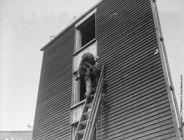 #2 A fireman rescuing someone during a gas mask class for London firemen, 1928.