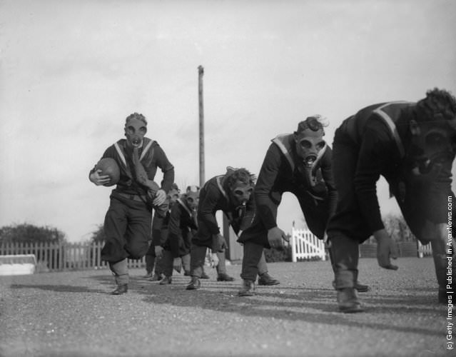 #10 Royal Navy seamen playing ball games in gas masks at the Anti-Gas School, Portsmouth, 1934.