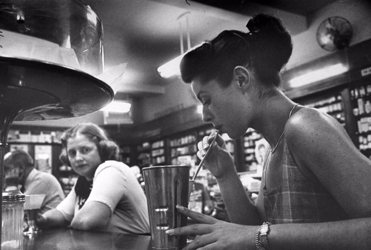 Hungry at drugstore after a day’s work earning money for nursing school, Dorothy envies slim girl’s milkshake, orders lemonade without sugar for herself.