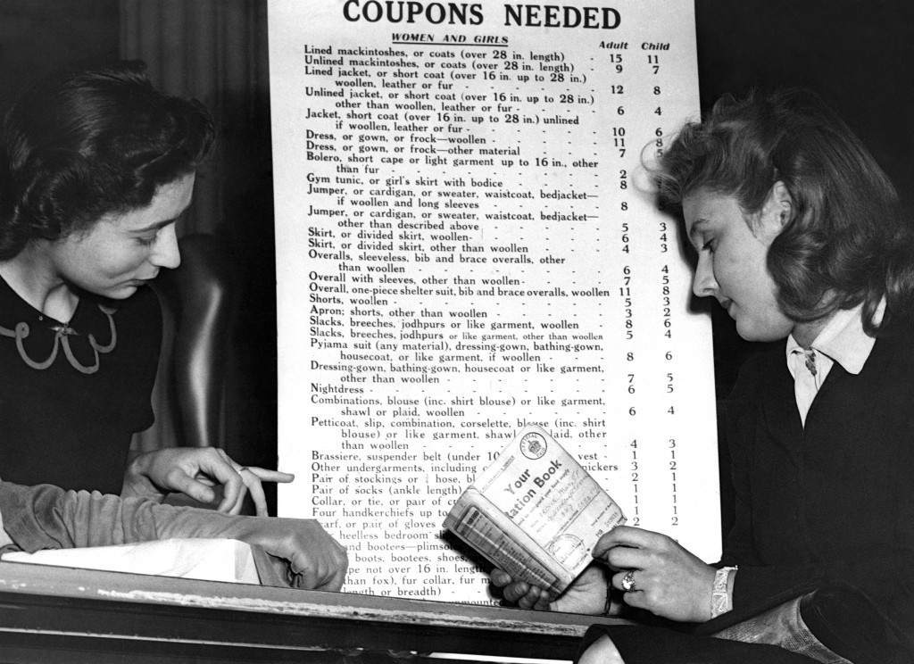 #15 A London shopper studies a coupon chart in a west end store, 1942.