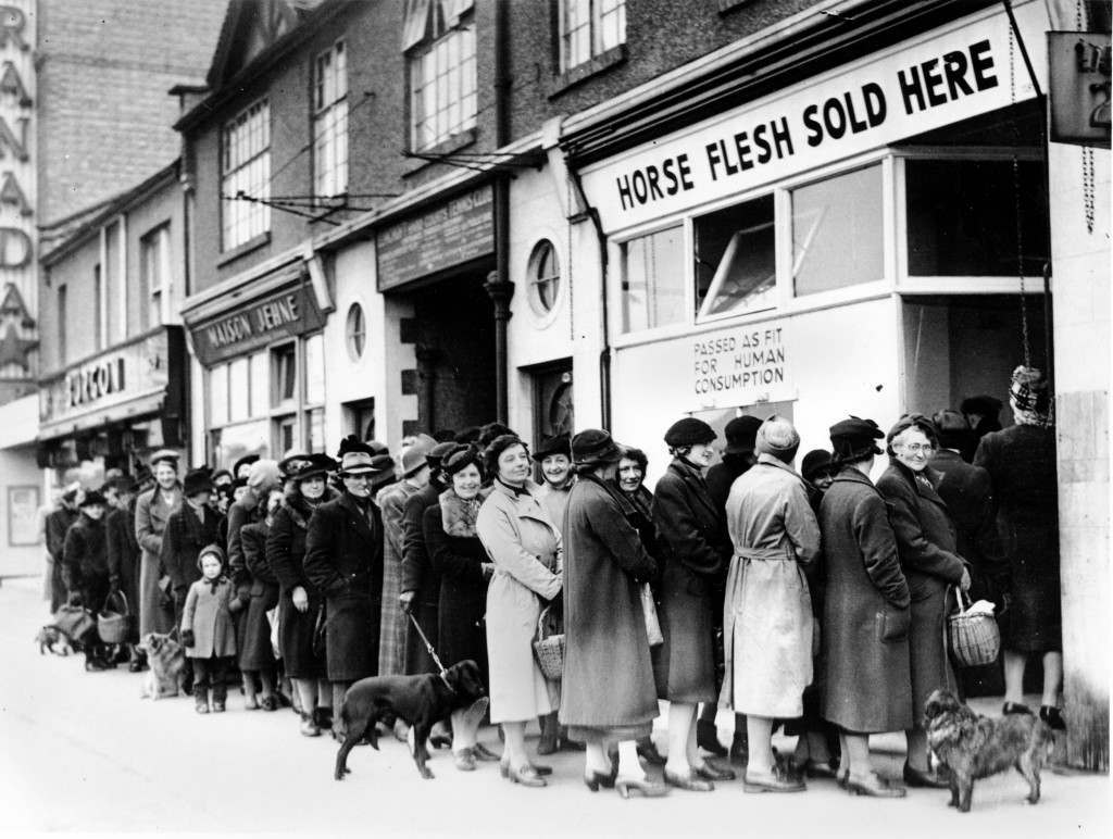 #17 Women line up outside a butcher shop to buy meat in North Cheam, Surrey, 1942.