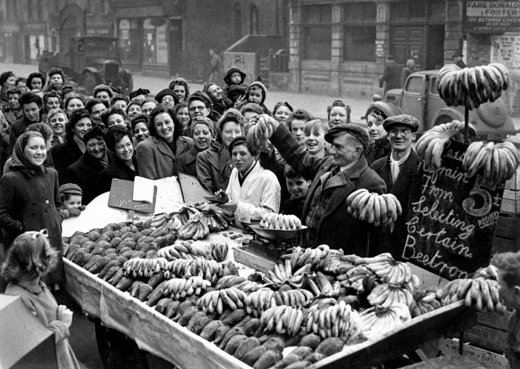 #23 Smiling women queueing for bananas in Bethnal Green, East London, 1946.