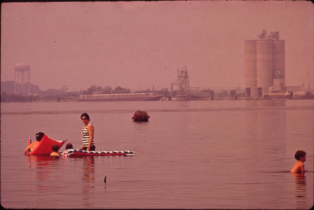 #6 Swimming in polluted Lake Charles, with the Olin-Mathieson Plant in the background, 1972.