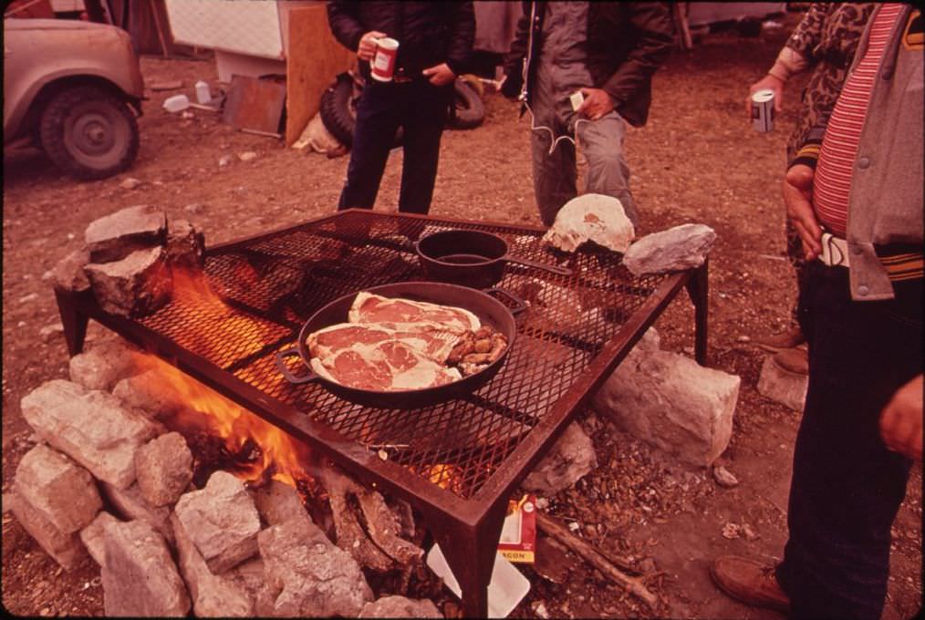 #18 Deer hunters preparing a meal at their permanent camp, 1972.
