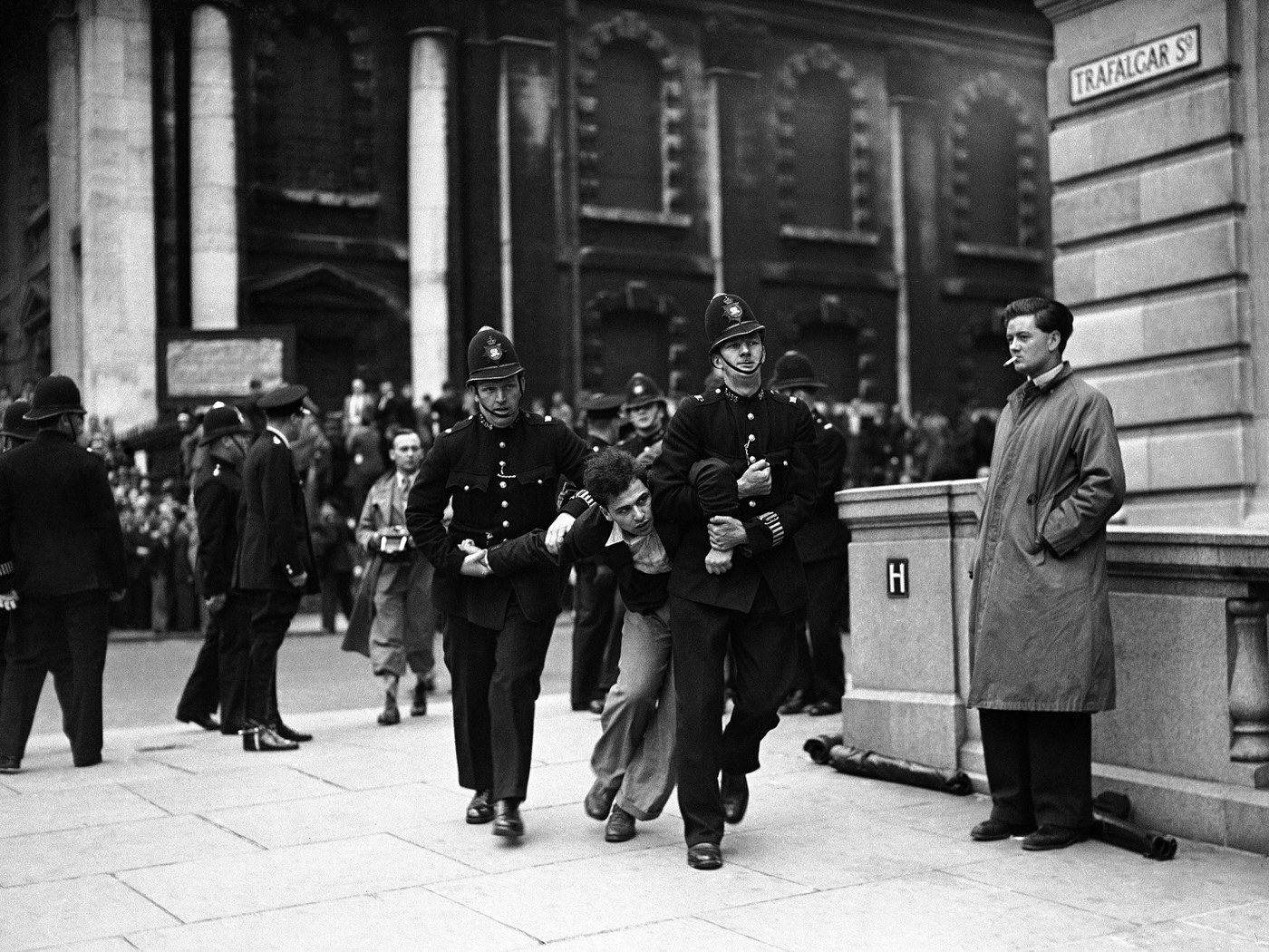#16 A demonstrator clashing with police during Sir Oswald Mosley’s fascist march in Trafalgar Square, 1937.
