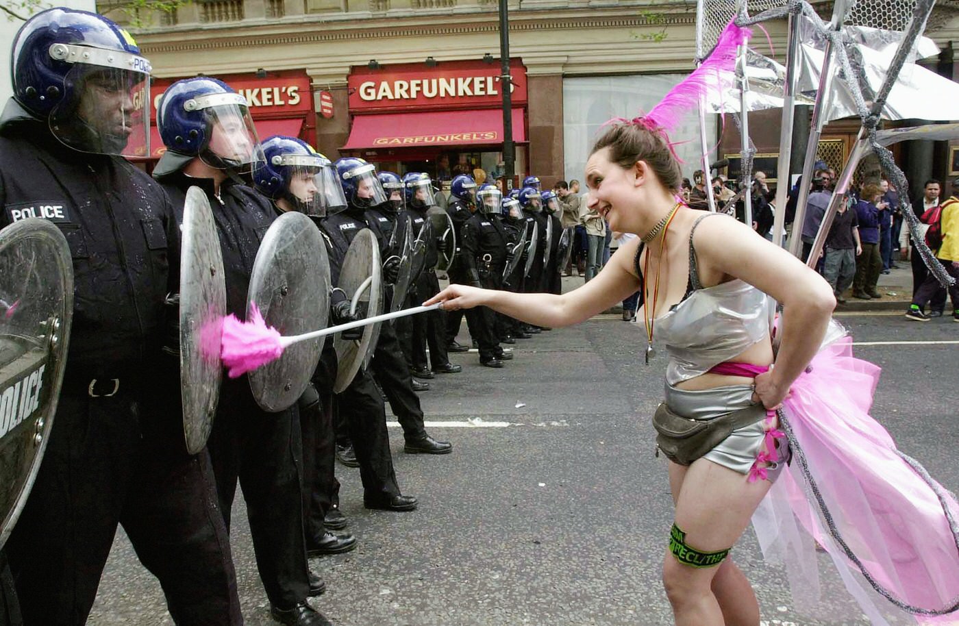 #68 An anti-capitalist demonstrator taunting riot police in Trafalgar Square, 2000.