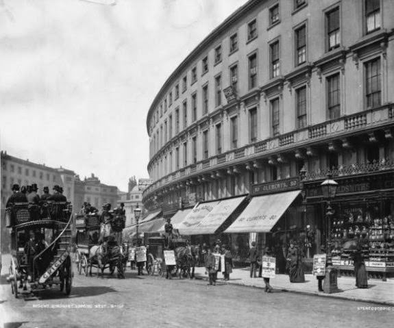 #12 Horse-drawn buses passing sandwich board men on Regent Quadrant, London, 1890.