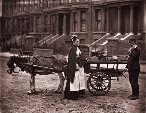 #16 A Victorian fruit seller selling strawberries in a London street, 1873.