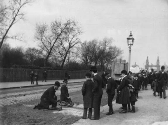#20 A street game of skittles at the Chelsea Bridge Road Fair, London, 1890.