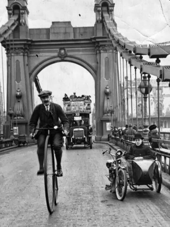 #3 A cyclist on a penny farthing over Hammersmith Bridge, London, 1800s.