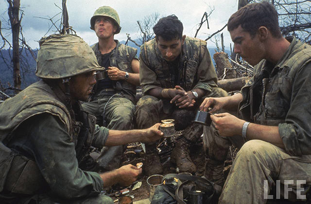 #1 US Marines eating rations during a lull in the fighting near the DMZ during the Vietnam War.
