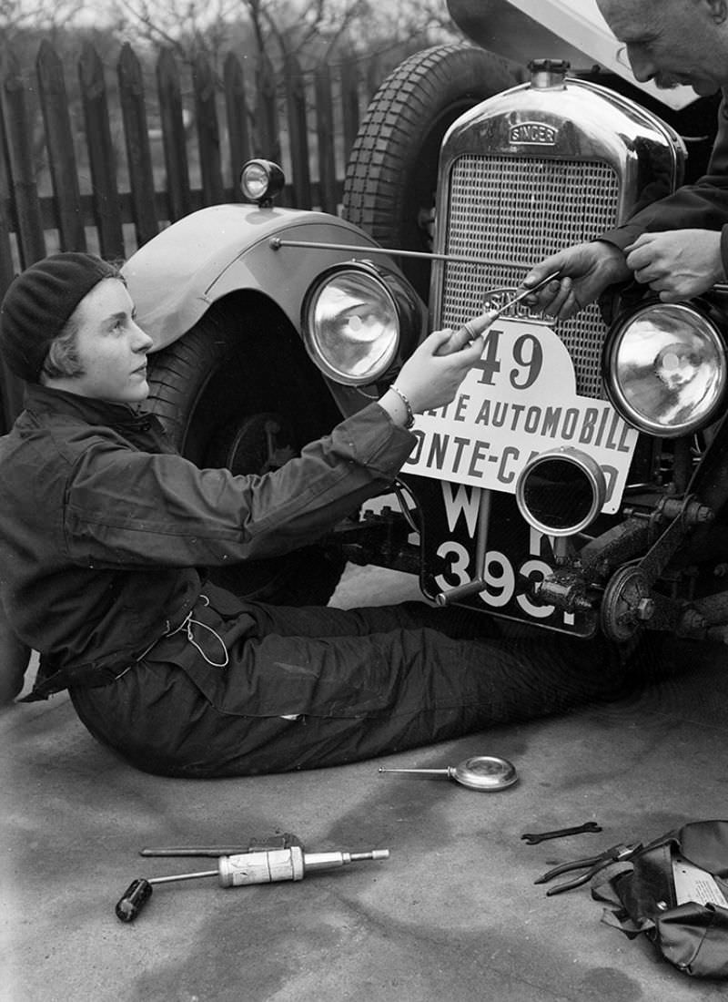 #12 Kitty Brunell works on a Singer Junior 848 cc at the Monte Carlo Rally, 1928.