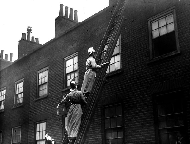 Members of the Women’s Fire Brigade on a fire drill, 1916.