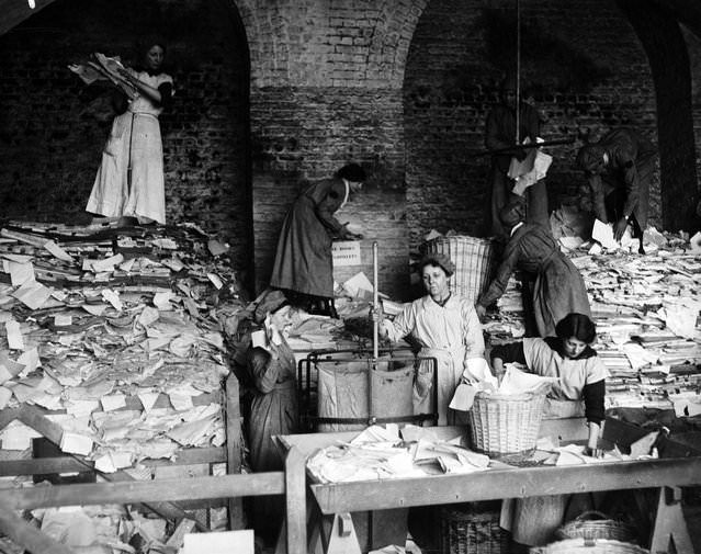 Women sorting paper for the London &; South West Railway, 1917.