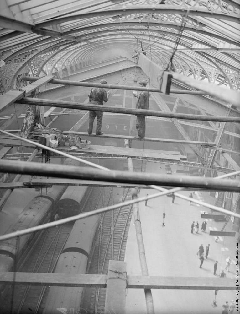 #15 Workmen painting girders beneath the roof of Liverpool Street Station, London, 1935.