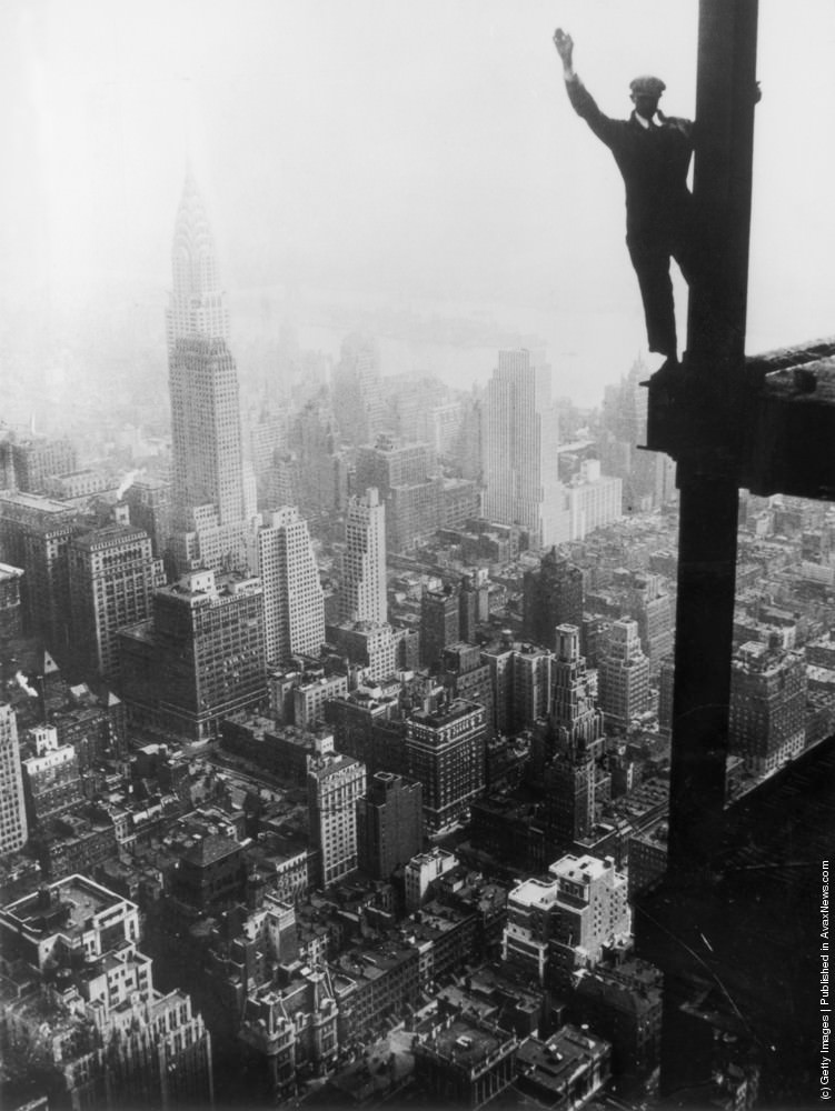 A steel worker balances on a girder during the construction of the Empire State Building in New York City, 1931.