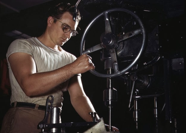 An employee runs mounting holes in a dural casting at North American’s machine shop in Inglewood, California, 1942.